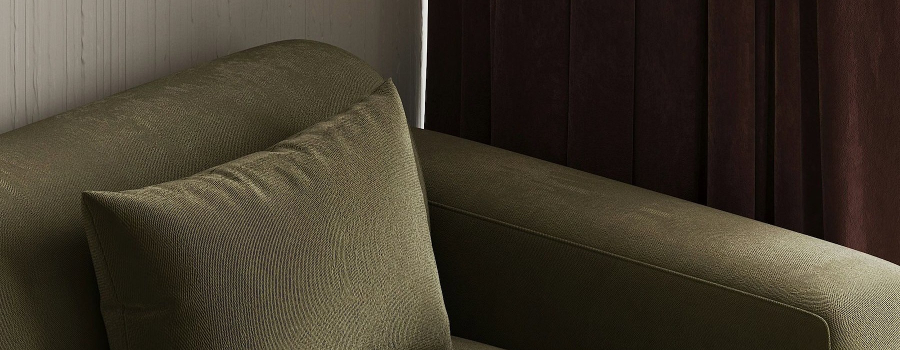 a green couch with pillows