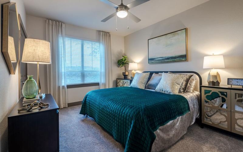 a bedroom with a bed and lamps